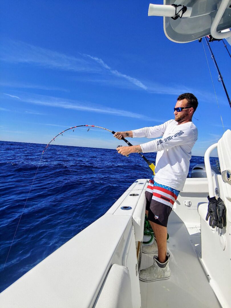 Man trying to catch fish using fishing rod